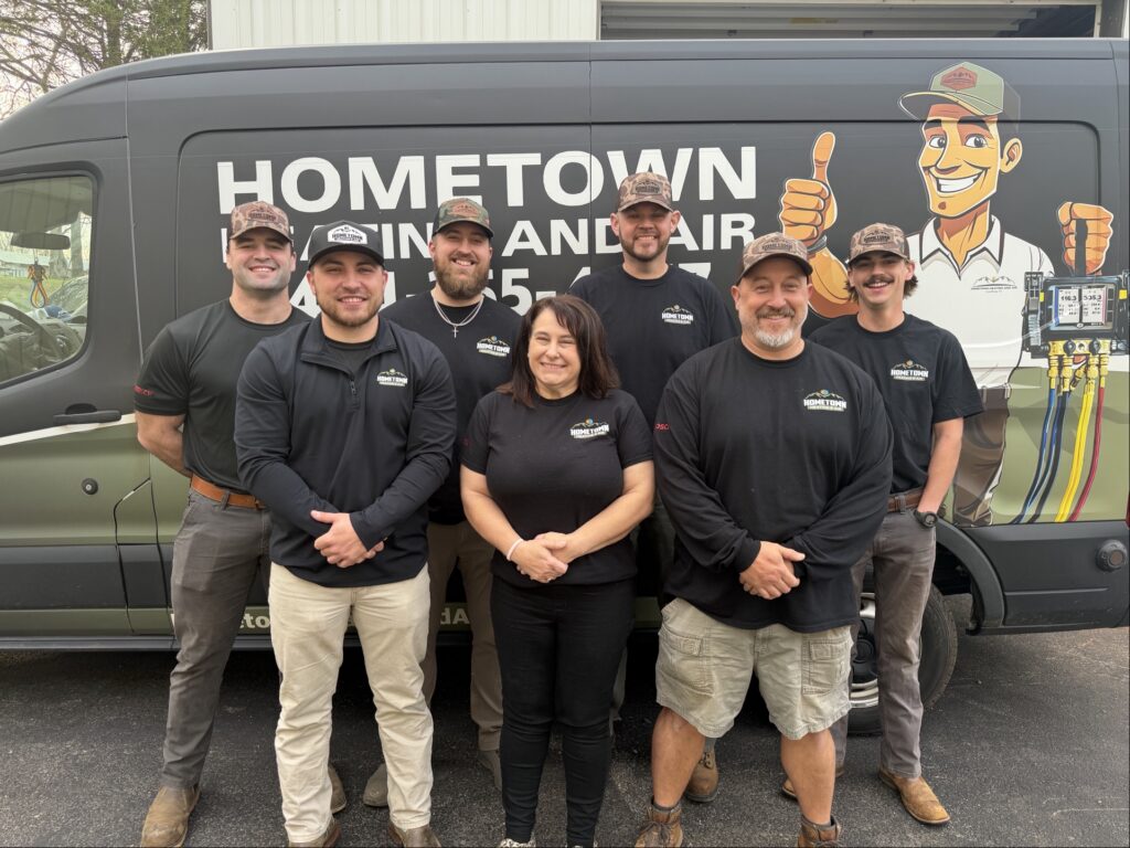 Hometown Heating and Air team standing in front of service van in Lynchburg VA