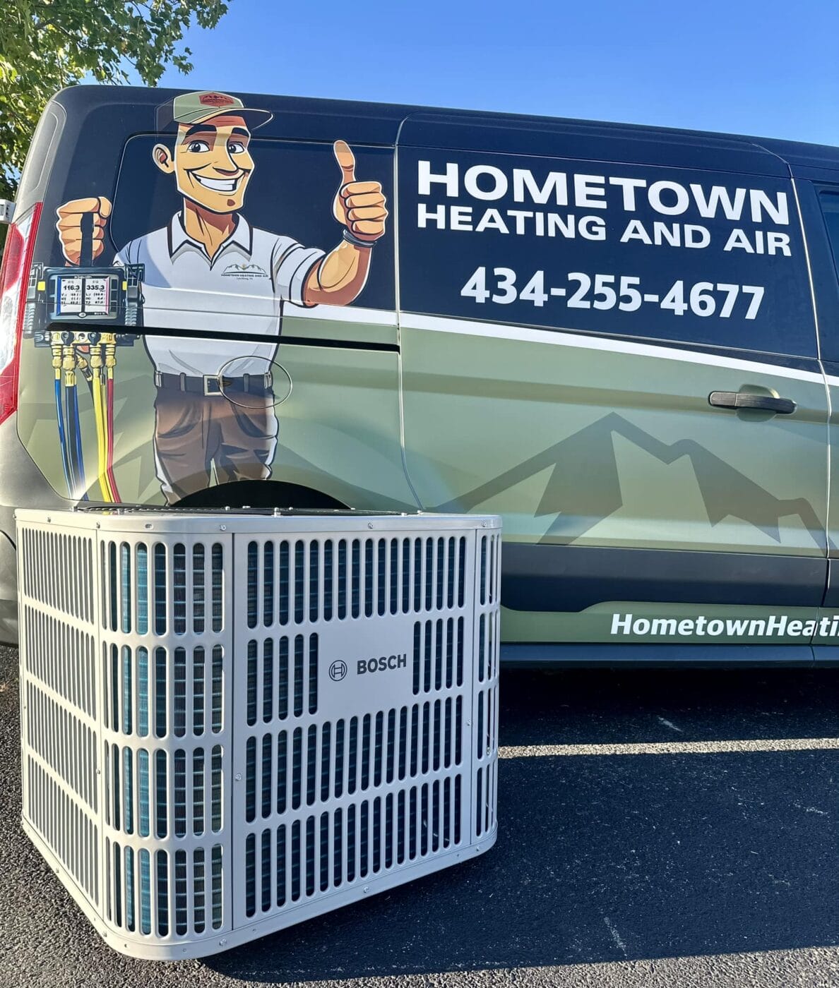 A Bosch HVAC unit is placed in front of a Hometown Heating and Air service van, which is displaying the company logo and contact number.