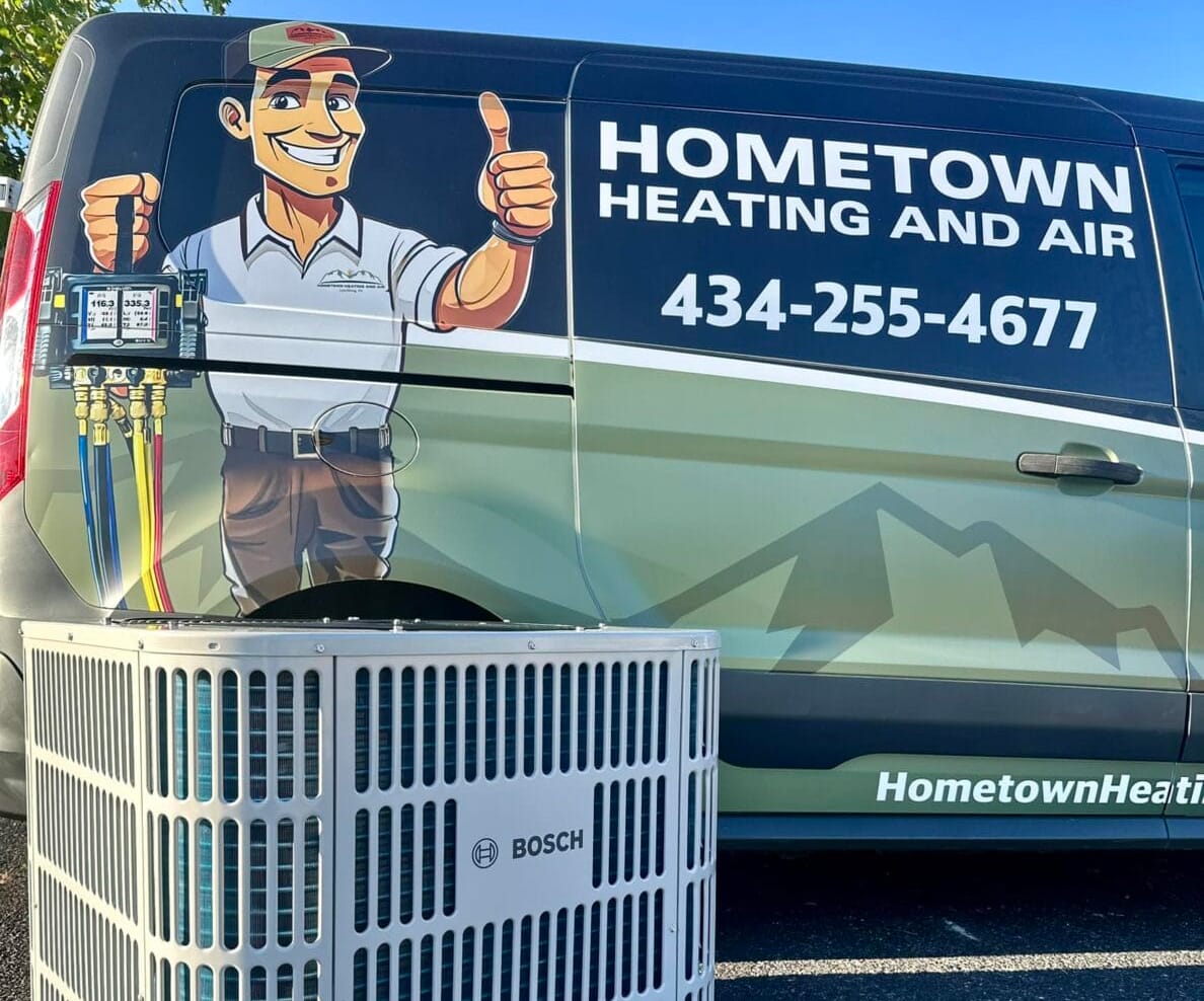 A Hometown Heating and Air van next to a Bosch HVAC unit. The van features the company details and a cartoon technician giving a thumbs-up.